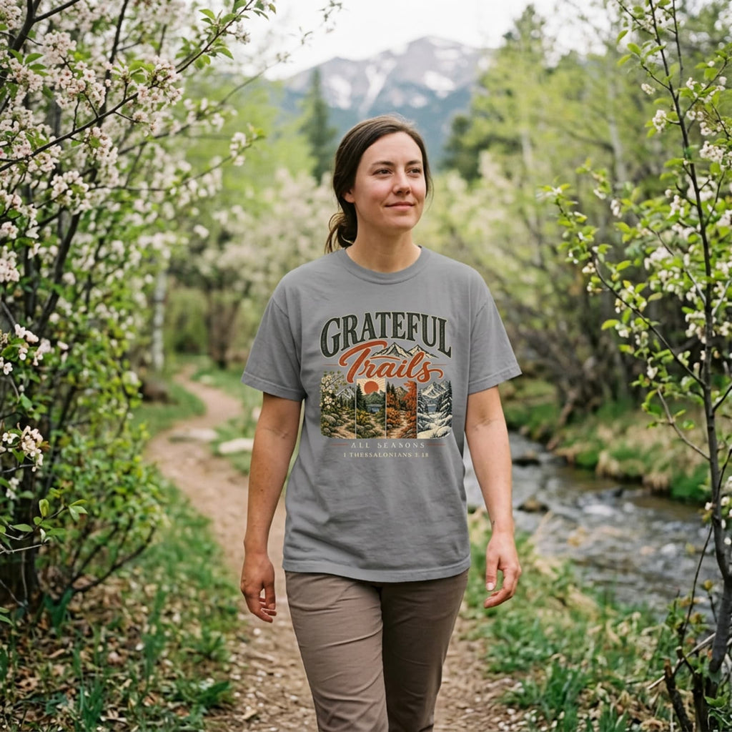 Woman hiking in an grey Grateful Trails Christian t-shirt on a mountain trail