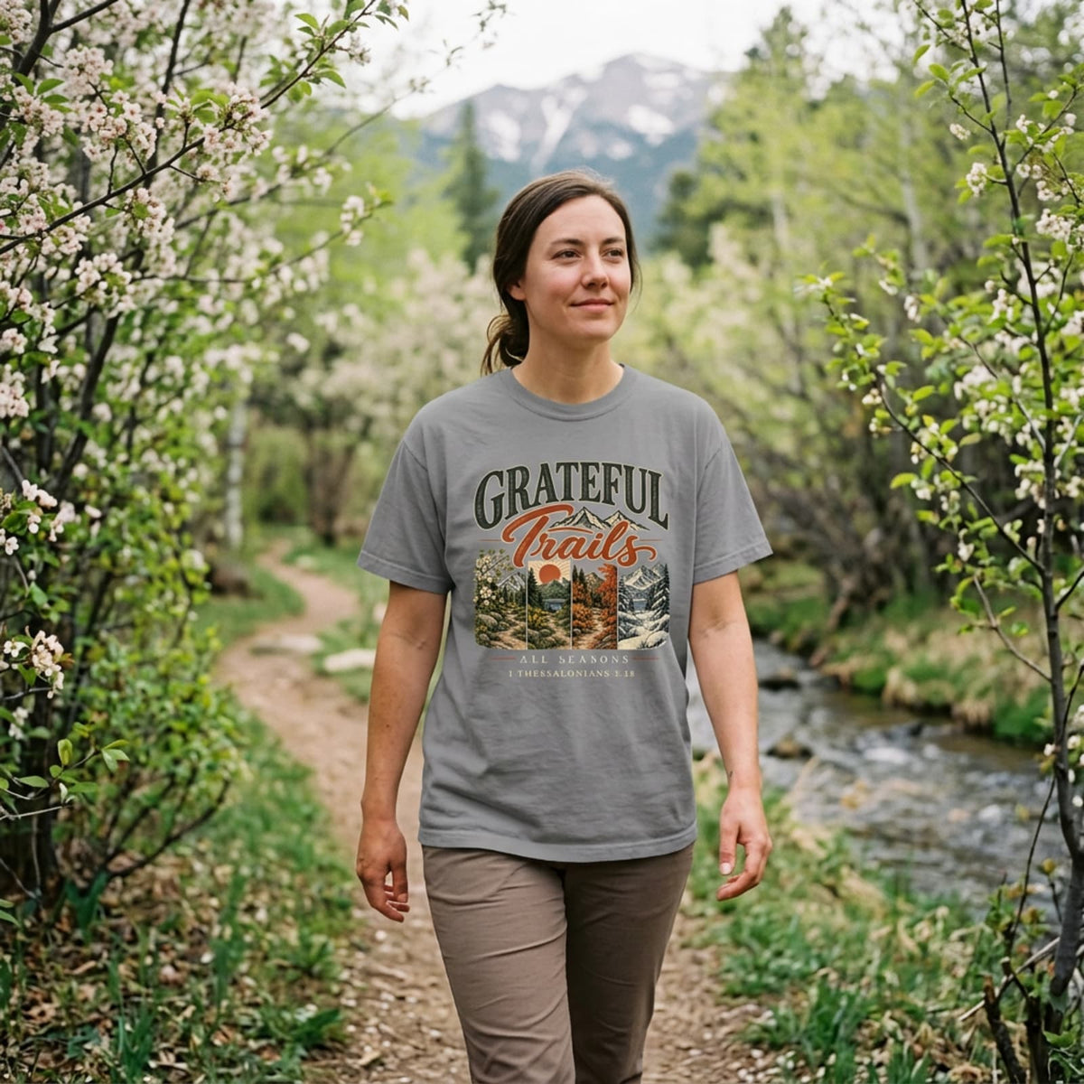 Woman hiking in an grey Grateful Trails Christian t-shirt on a mountain trail