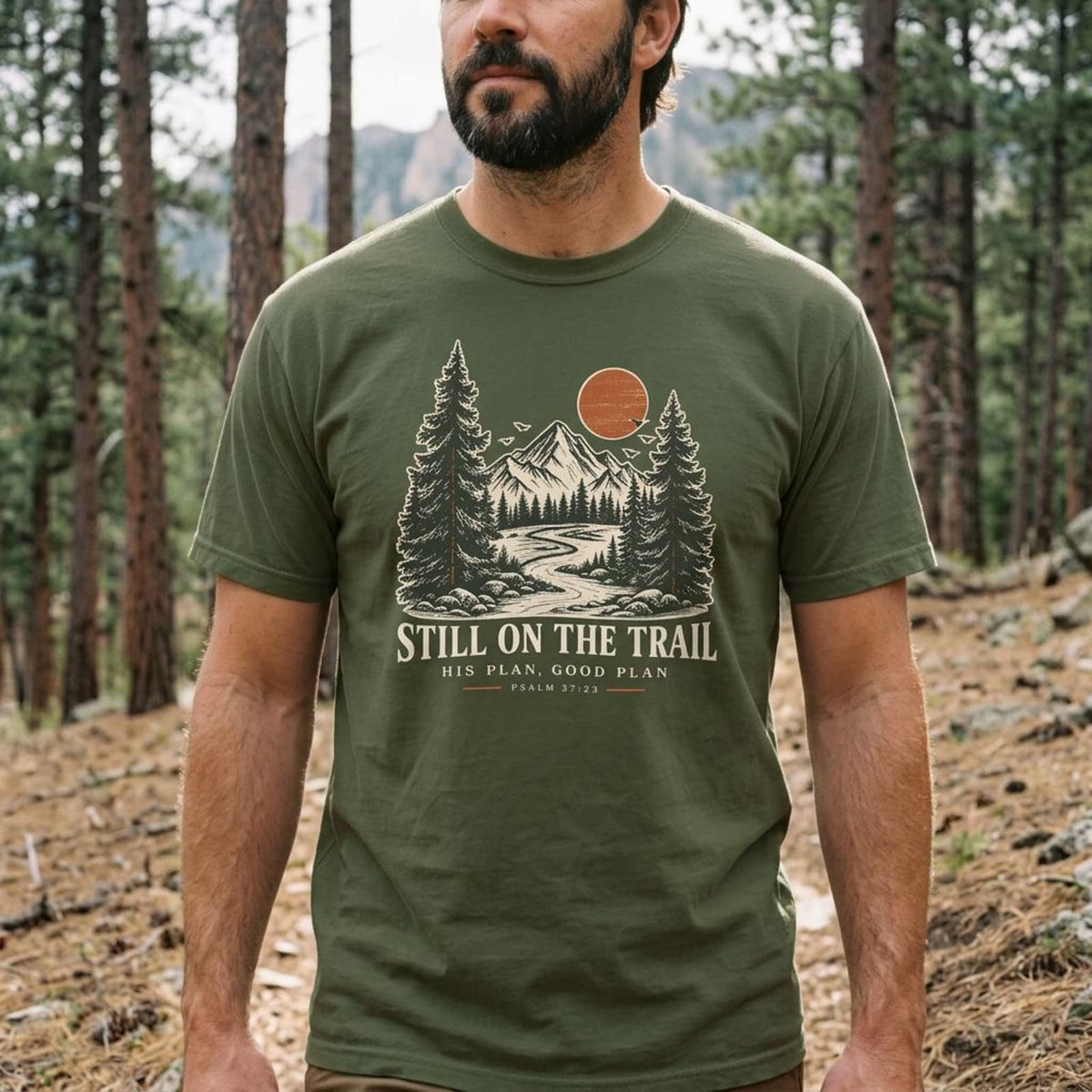 Man wearing the Still on the Trail Christian hiking T-shirt with a vintage outdoor design.