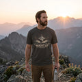 Man hiking in a Pepper They Shall Mount Up Christian t-shirt on a mountain ridge