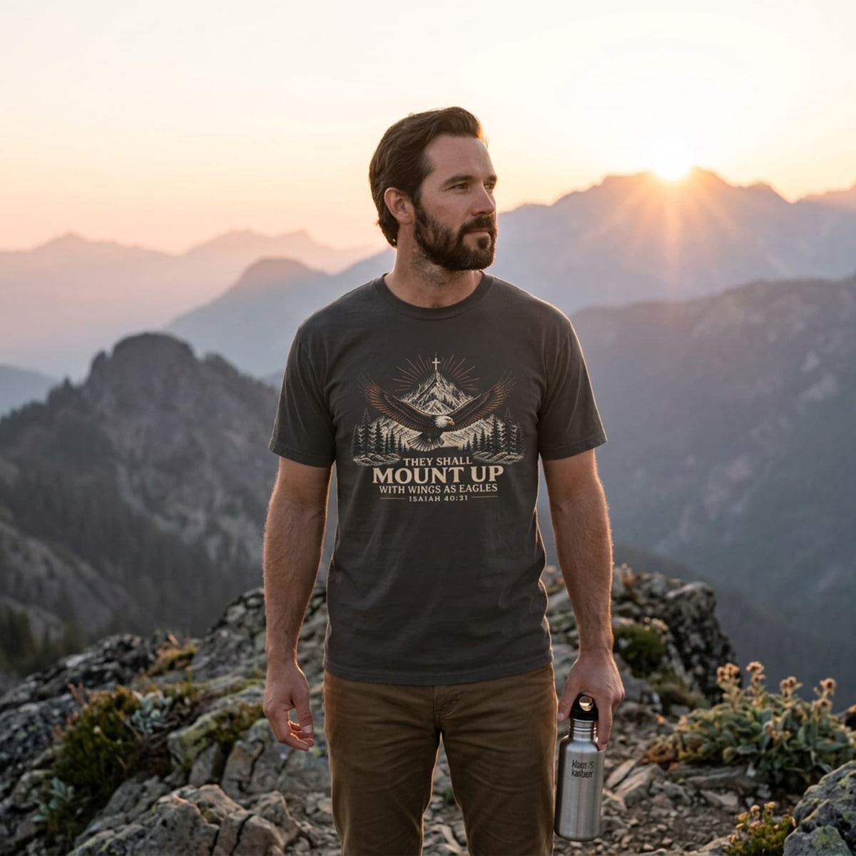 Man hiking in a Pepper They Shall Mount Up Christian t-shirt on a mountain ridge