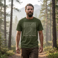 Man hiking in a Sage Trust the Trail Christian t-shirt on a mountain trail